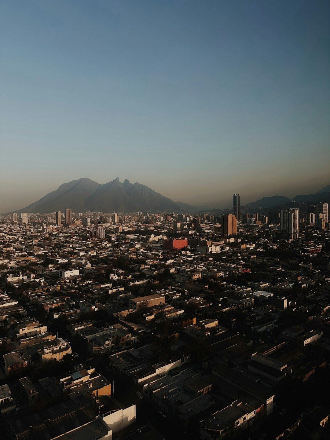 Aerial view of a Chilean city grid with mountains in the distance