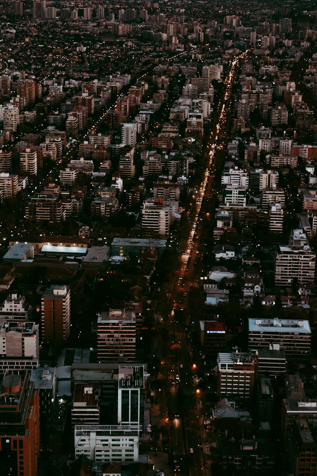 Street level view of an urban avenue in Chile at dusk